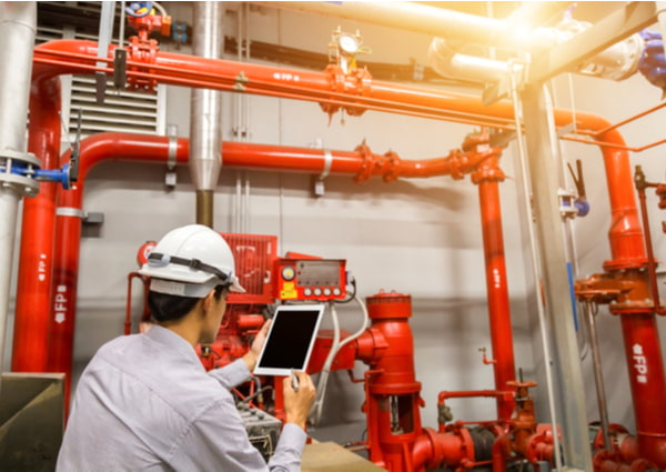 Engineer with tablet check red generator pump