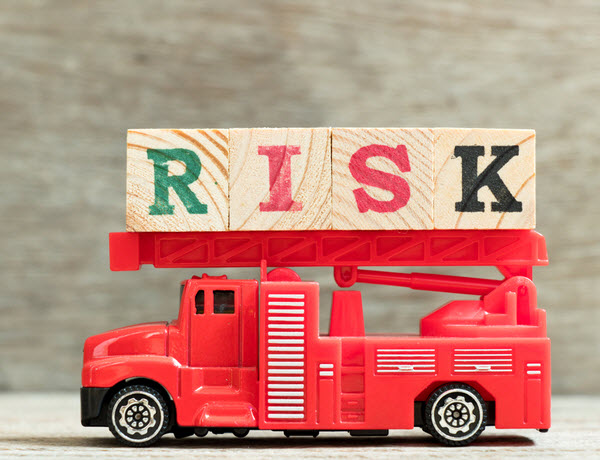 Red fire truck with ladder hold block word risk