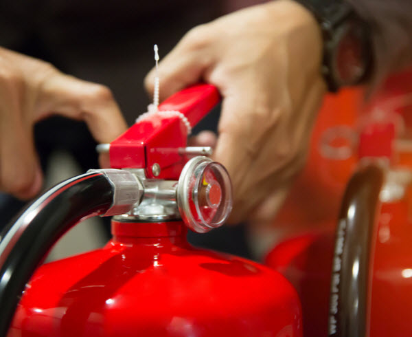 Engineer pulling pin of Fire extinguisher for fire and safety