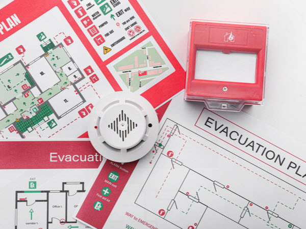 Evacuation plans, smoke detector and manual call point