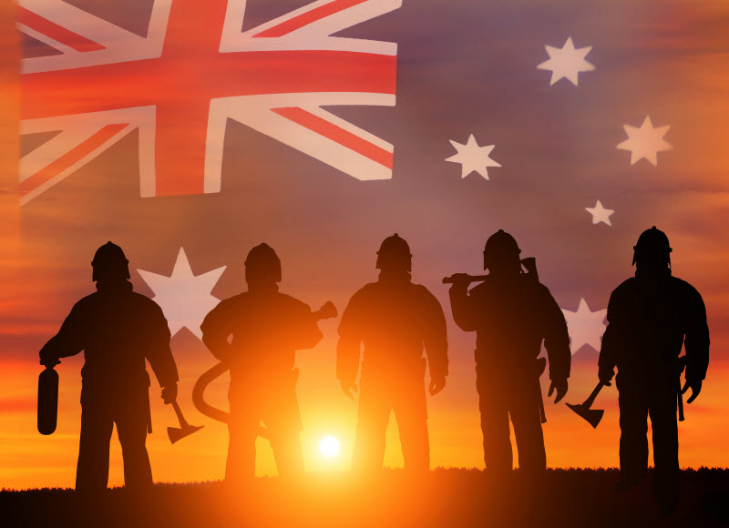 Silhouette shot of fire fighters with sunrise at the center and Australia flag at the background